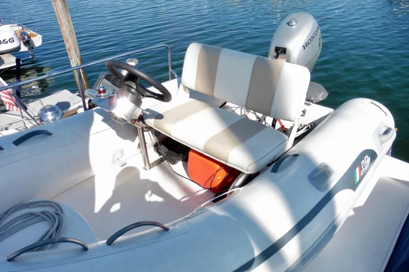 Kokomo Yacht Photos Pics Inflatable boat with steering wheel and Honda motor, docked on calm water. Ocean Alexander 423 Classico, 2000.