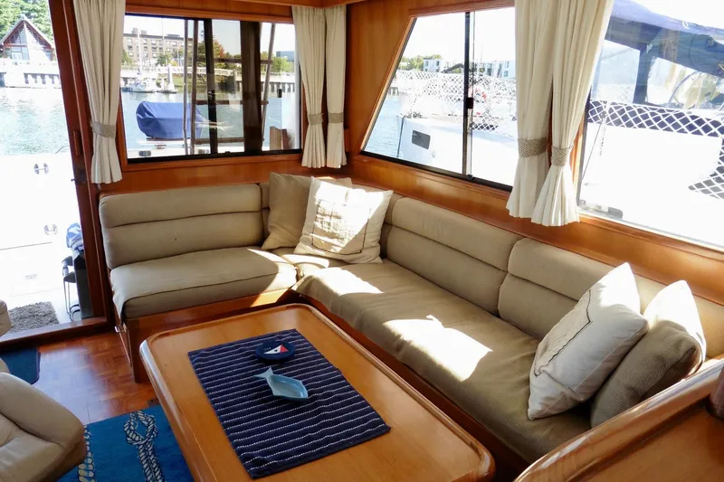 Kokomo Yacht Photos Pics Cozy interior of 2000 Ocean Alexander 423 Classico yacht with beige seating and wooden accents.