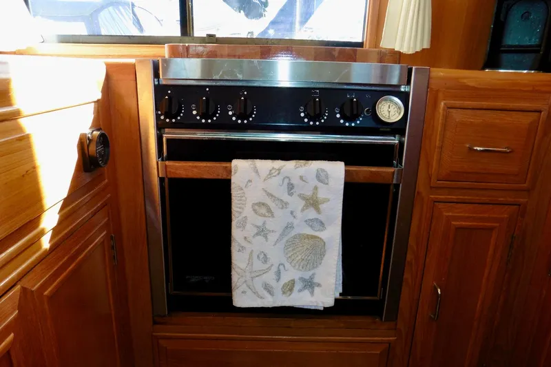 Kokomo Yacht Photos Pics Wooden kitchen interior with an oven in a 2000 Ocean Alexander 423 Classico yacht.