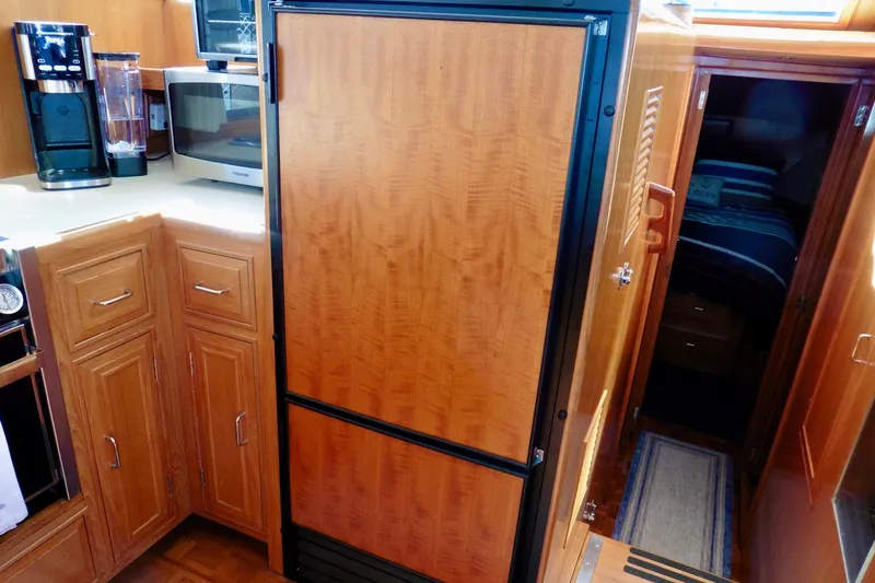 Kokomo Yacht Photos Pics Interior of 2000 Ocean Alexander 423 Classico yacht kitchen with wood cabinetry and appliances.