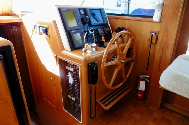 Kokomo Yacht Photos Pics Helm station of 2000 Ocean Alexander 423 Classico with wooden wheel and navigation equipment.