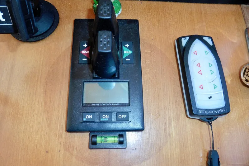 Kokomo Yacht Photos Pics Control panel and remote for 2000 Ocean Alexander 423 Classico yacht, featuring navigation controls.