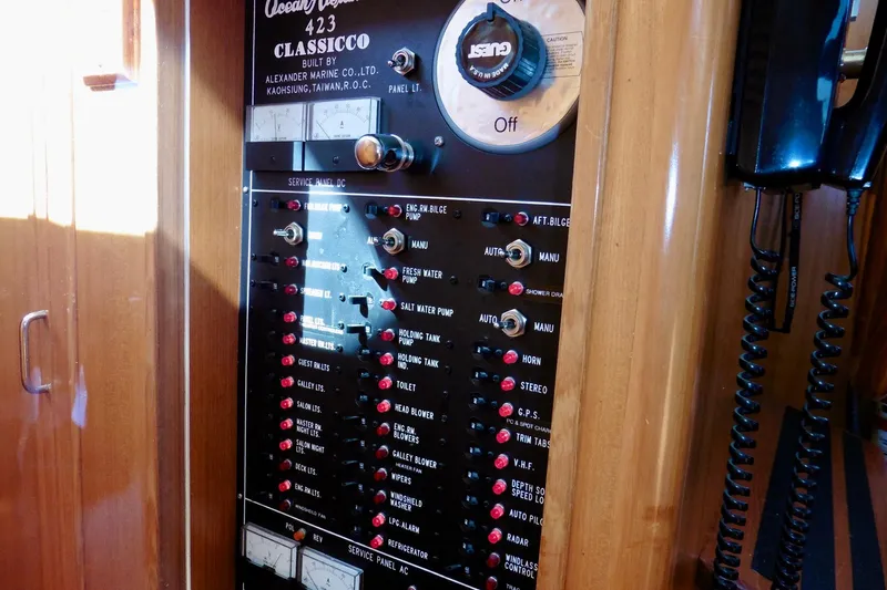 Kokomo Yacht Photos Pics Electrical control panel of 2000 Ocean Alexander 423 Classico yacht, featuring various switches and gauges.