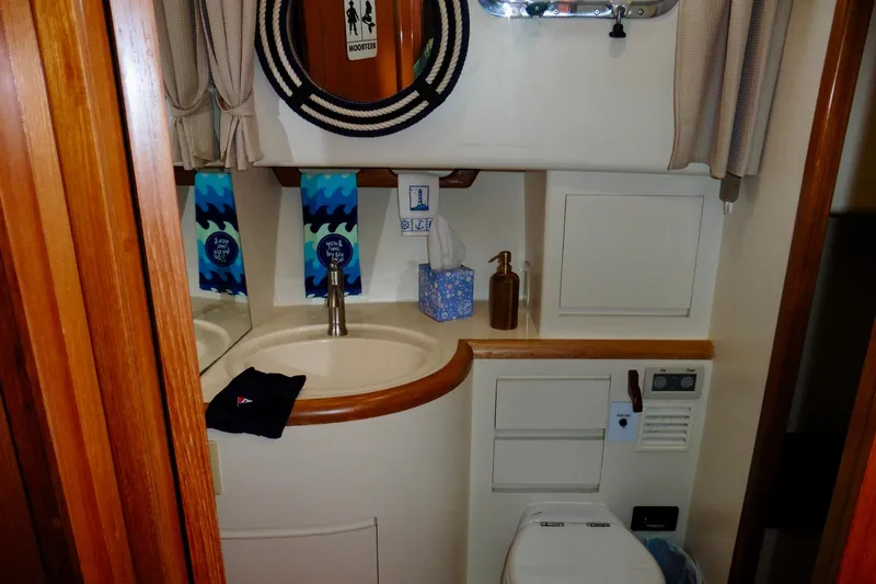 Kokomo Yacht Photos Pics Bathroom interior of 2000 Ocean Alexander 423 Classico yacht, featuring sink and toilet.