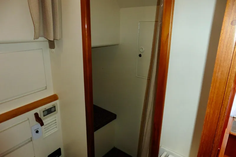 Kokomo Yacht Photos Pics Interior view of 2000 Ocean Alexander 423 Classico yacht, featuring wooden trim and storage space.