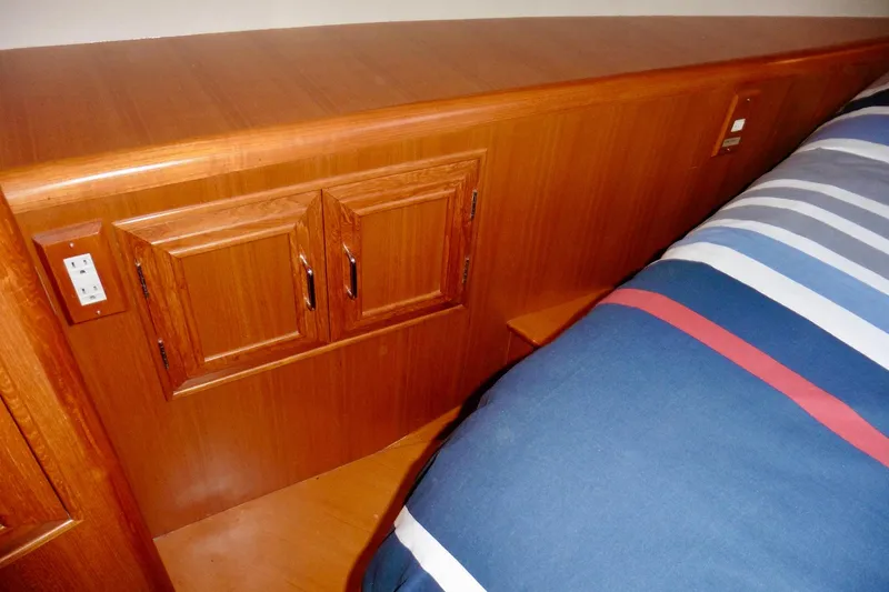 Kokomo Yacht Photos Pics Wooden interior of 2000 Ocean Alexander 423 Classico yacht with striped bedding.