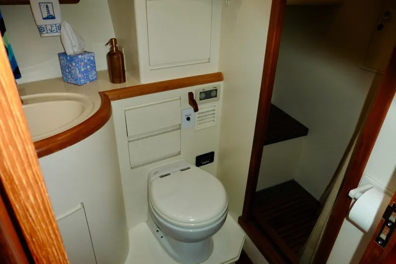 Kokomo Yacht Photos Pics Bathroom interior of 2000 Ocean Alexander 423 Classico yacht, featuring toilet and sink.