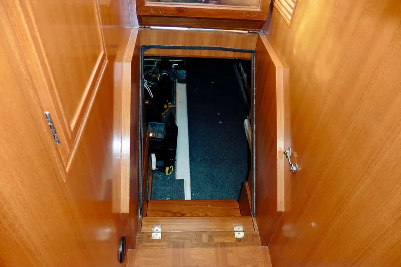 Kokomo Yacht Photos Pics Engine room access on 2000 Ocean Alexander 423 Classico yacht, featuring wooden interior.
