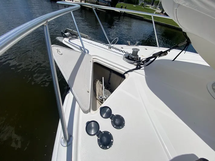 Pretty Fine Yacht Photos Pics 2003 Riviera 47 Convertible yacht deck with anchor storage and railing.