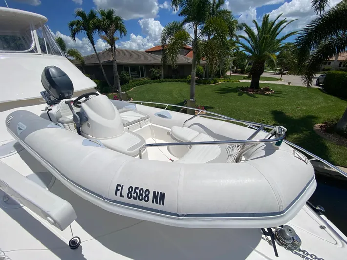 Pretty Fine Yacht Photos Pics Inflatable boat on 2003 Riviera 47 Convertible yacht, docked near palm trees.
