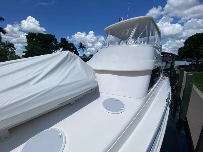 Pretty Fine Yacht Photos Pics 2003 Riviera 47 Convertible yacht docked under a clear blue sky.