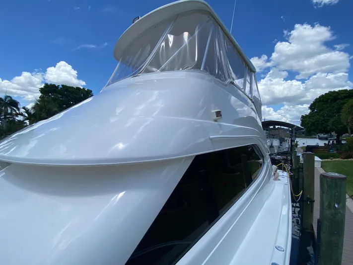 Pretty Fine Yacht Photos Pics 2003 Riviera 47 Convertible yacht docked under a clear blue sky.