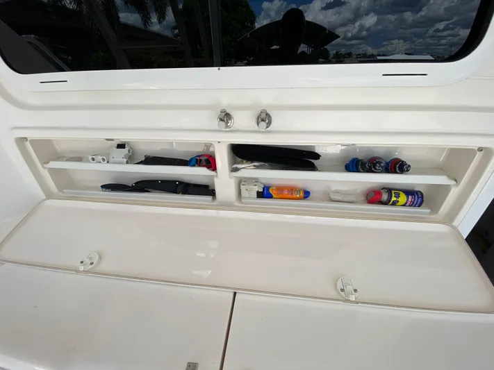 Pretty Fine Yacht Photos Pics Storage compartment on a 2003 Riviera 47 Convertible boat, containing various tools and supplies.