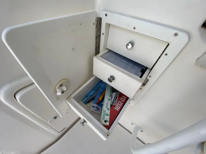 Pretty Fine Yacht Photos Pics Open storage compartment on 2003 Riviera 47 Convertible boat with fishing gear.