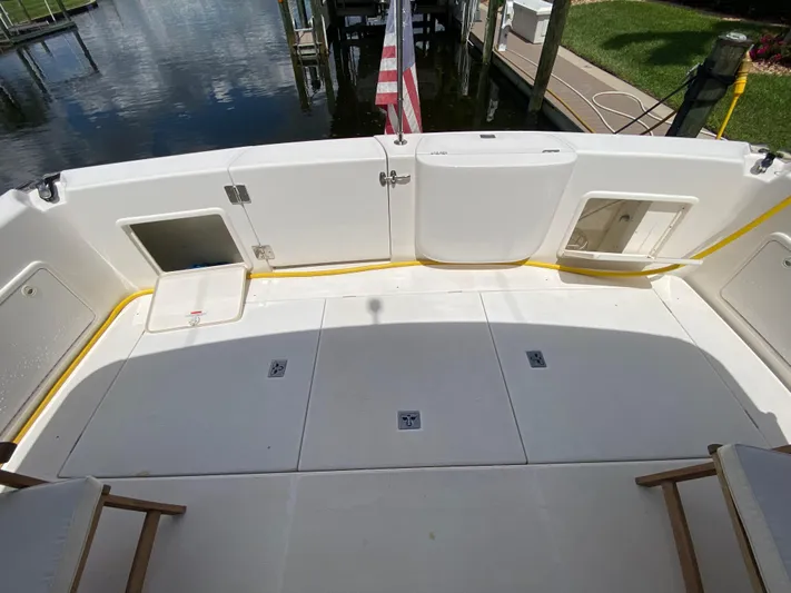 Pretty Fine Yacht Photos Pics 2003 Riviera 47 Convertible yacht deck with storage compartments and American flag.