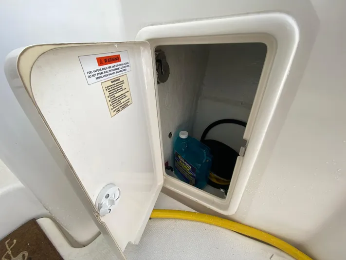 Pretty Fine Yacht Photos Pics Storage compartment on 2003 Riviera 47 Convertible boat with warning label and cleaning supplies.