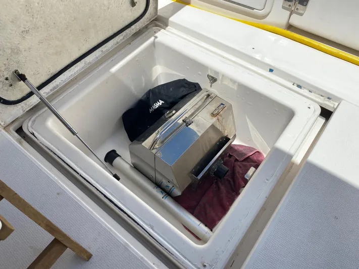 Pretty Fine Yacht Photos Pics Open storage compartment on 2003 Riviera 47 Convertible boat with grill and accessories.