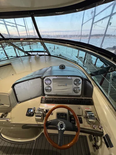 Lucky 9 Yacht Photos Pics 2007 Sea Ray 38 Sundancer helm with Garmin navigation, overlooking marina waters.
