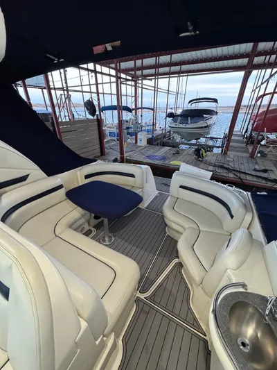 Lucky 9 Yacht Photos Pics 2007 Sea Ray 38 Sundancer interior with seating and table, docked at marina.
