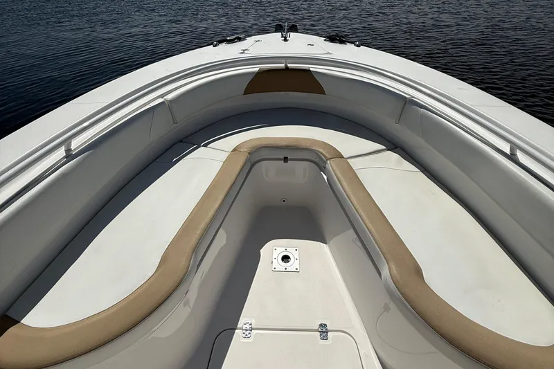  Yacht Photos Pics 2017 Edgewater 320CC boat interior with cushioned seating, on calm water.