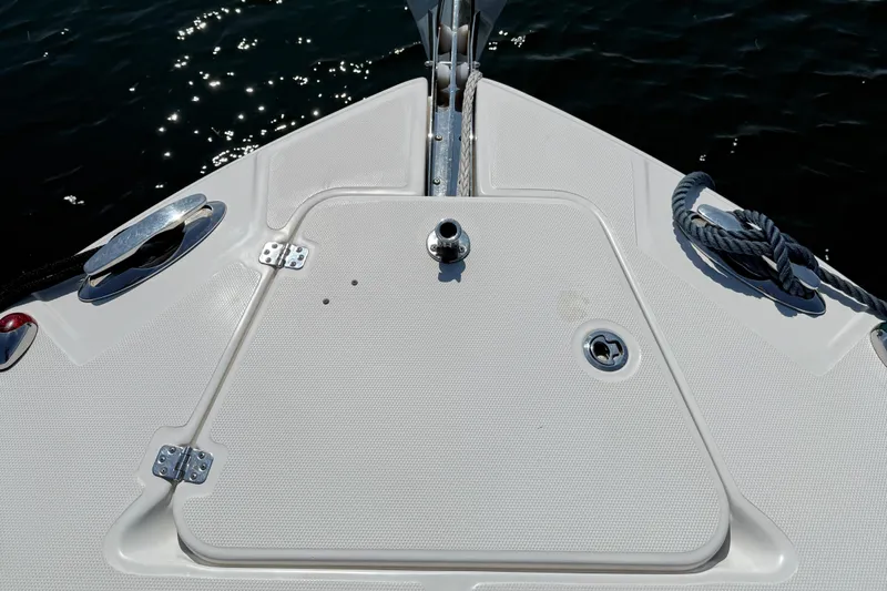  Yacht Photos Pics Bow of 2017 Edgewater 320CC boat with anchor hatch and rope, on water.