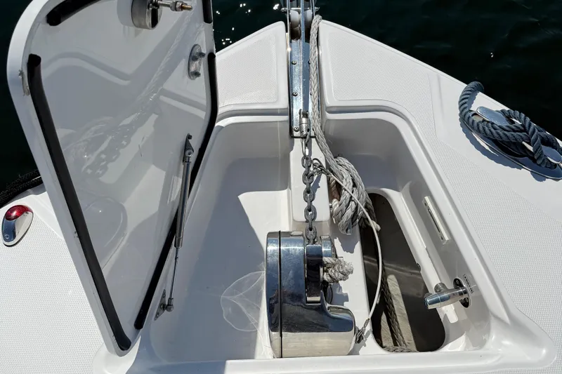  Yacht Photos Pics 2017 Edgewater 320CC boat anchor compartment with open hatch and visible winch.