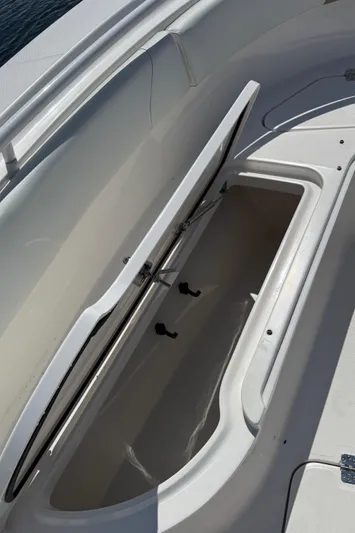  Yacht Photos Pics 2017 Edgewater 320CC boat storage compartment with open lid, showcasing spacious interior.