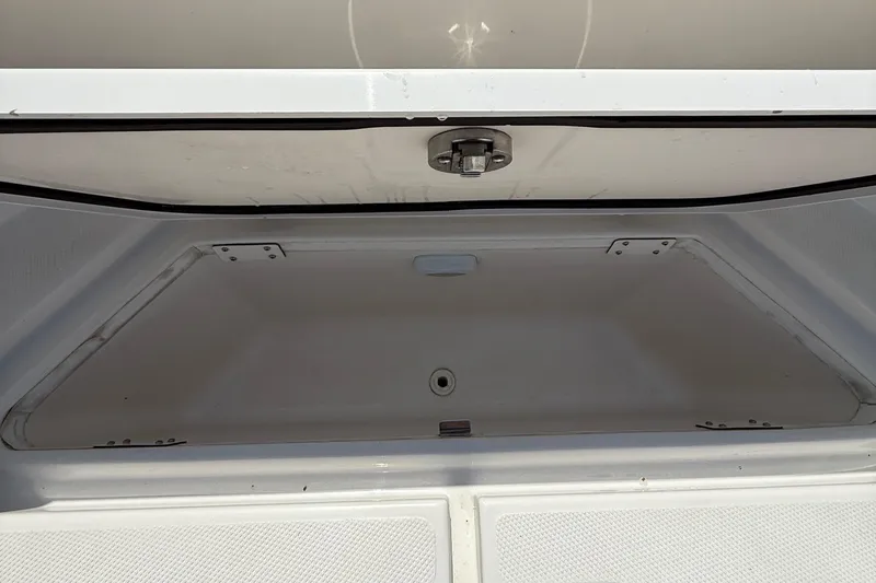 Yacht Photos Pics Open storage compartment of 2017 Edgewater 320CC boat, showcasing spacious interior.