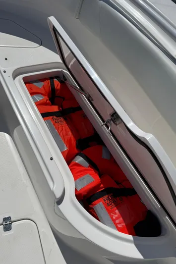  Yacht Photos Pics 2017 Edgewater 320CC boat storage compartment with orange life jackets.