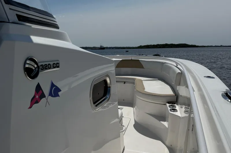  Yacht Photos Pics 2017 Edgewater 320CC boat on calm water, featuring sleek design and spacious seating.