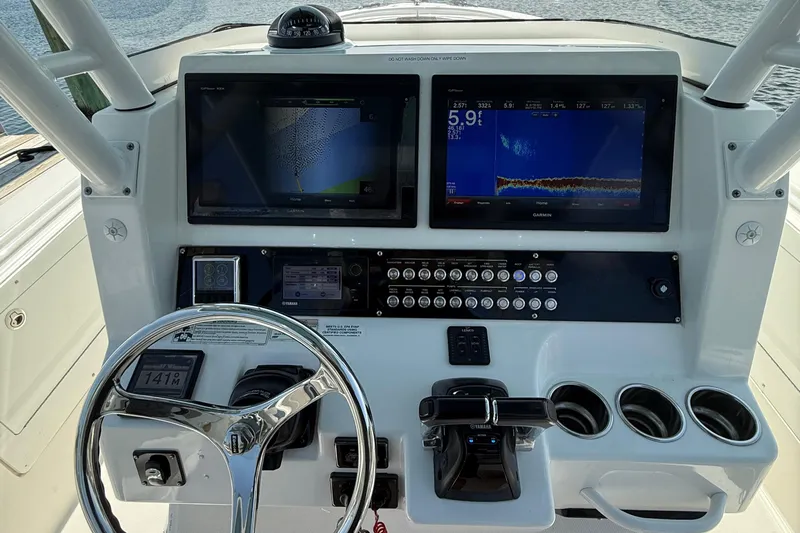  Yacht Photos Pics Control panel of 2017 Edgewater 320CC boat with navigation screens and steering wheel.