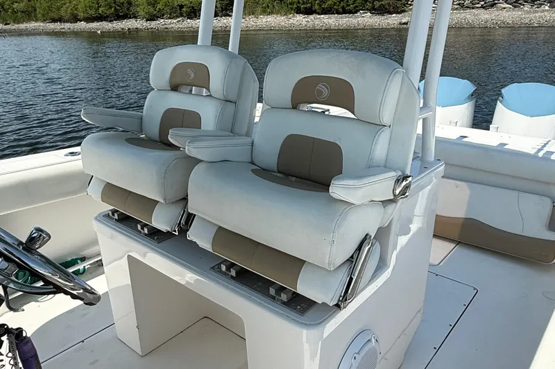  Yacht Photos Pics 2017 Edgewater 320CC boat seats with white and beige upholstery on a calm water backdrop.