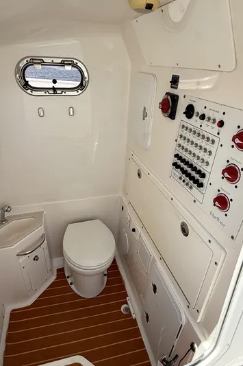  Yacht Photos Pics 2017 Edgewater 320CC boat interior with control panel and marine toilet.