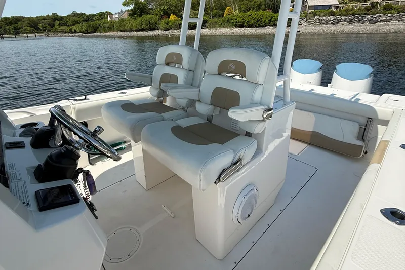  Yacht Photos Pics 2017 Edgewater 320CC boat interior with dual captain's chairs and steering console.