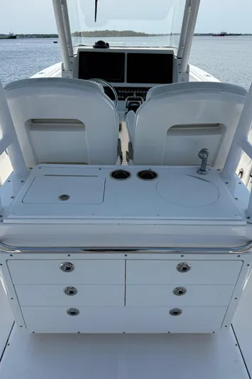  Yacht Photos Pics Edgewater 320CC 2017 boat interior with helm, storage, and ocean view.