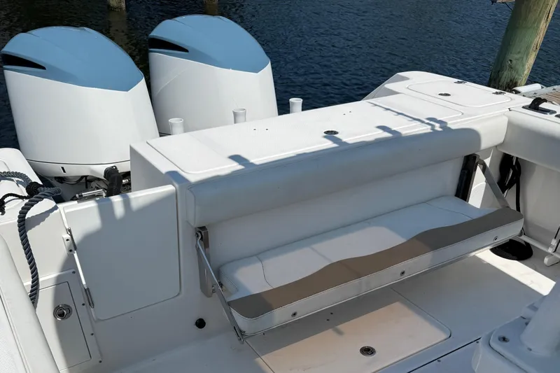  Yacht Photos Pics 2017 Edgewater 320CC boat with dual outboard engines and foldable seating on deck.