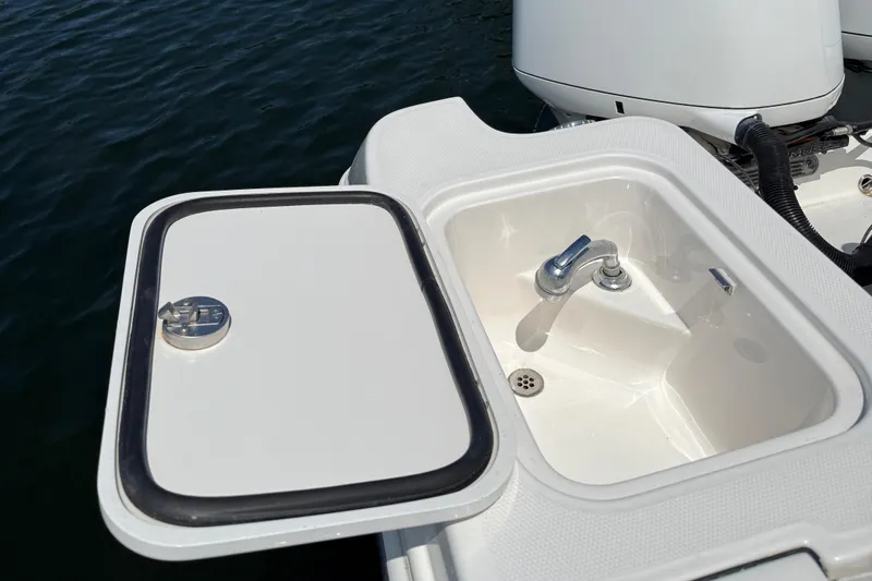  Yacht Photos Pics Edgewater 320CC 2017 boat sink with open lid, near water.