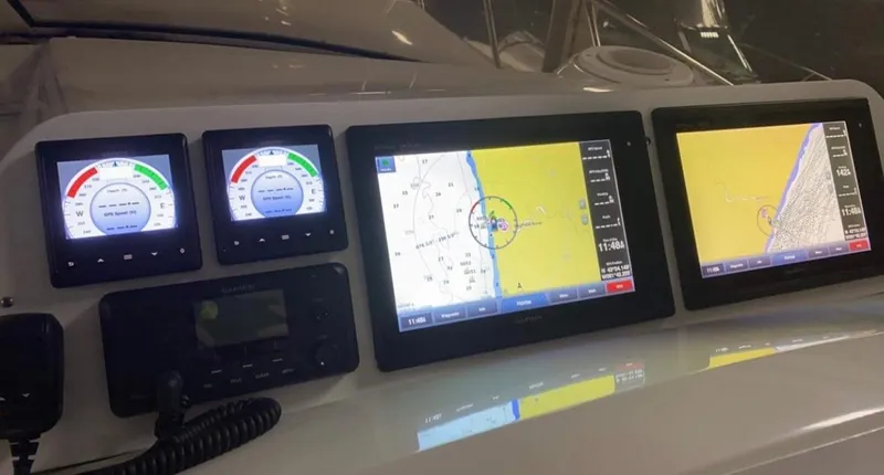 Dealer-ship Yacht Photos Pics Dashboard of 2004 Fountain 48 Express Cruiser with navigation and control displays.