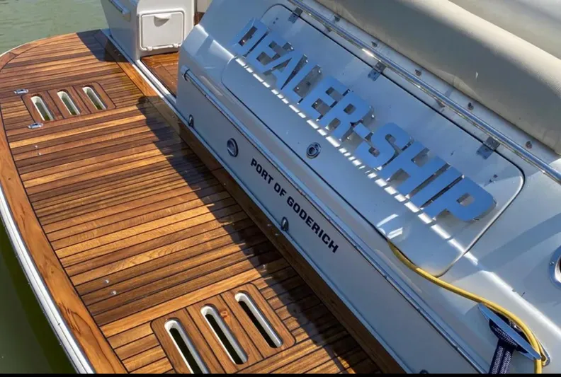 Dealer-ship Yacht Photos Pics 2004 Fountain 48 Express Cruiser with teak deck, labeled "DEALER-SHIP," docked at Port of Goderich.