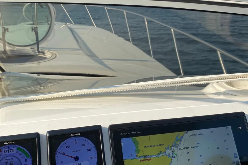 Dealer-ship Yacht Photos Pics 2004 Fountain 48 Express Cruiser dashboard with navigation screens and ocean view.