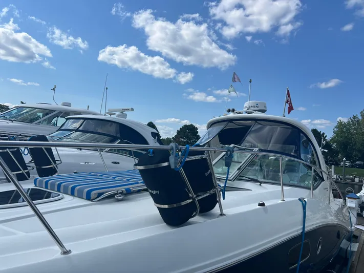 Baileys Dinghy Yacht Photos Pics Sea Ray 350 Sundancer 2010 yacht docked under a blue sky with clouds.