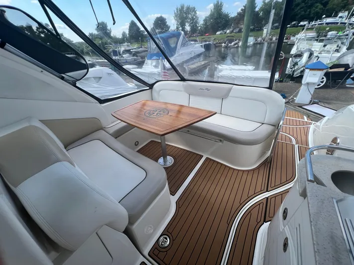 Baileys Dinghy Yacht Photos Pics 2010 Sea Ray 350 Sundancer interior with white seating and wooden table.