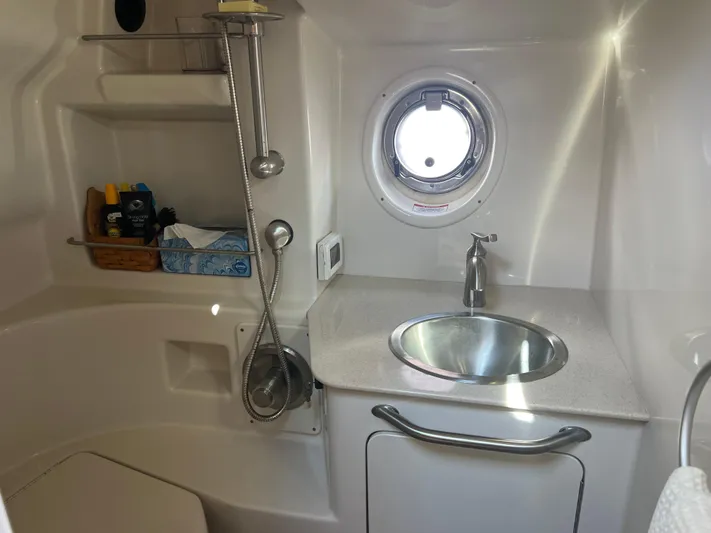 Baileys Dinghy Yacht Photos Pics Bathroom interior of 2010 Sea Ray 350 Sundancer with sink, porthole, and shower amenities.