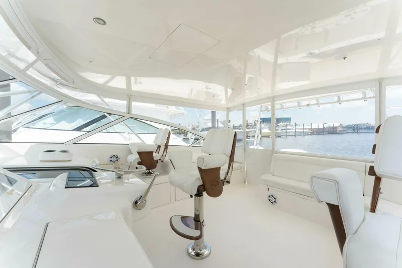 Wig Wag Yacht Photos Pics Interior of a 2009 Viking 45 Open yacht with white seating and panoramic windows.