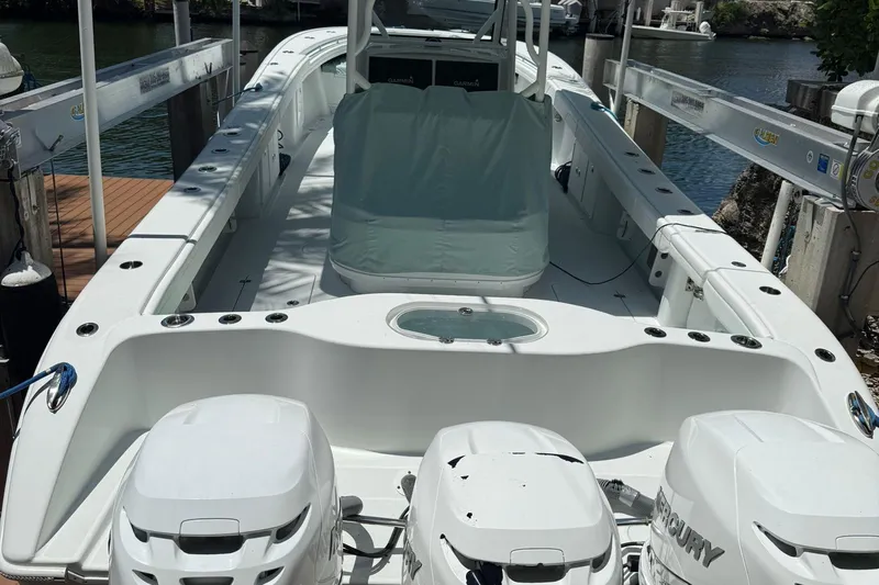  Yacht Photos Pics 2021 Yellowfin 39 boat docked, featuring triple Mercury engines and spacious deck layout.