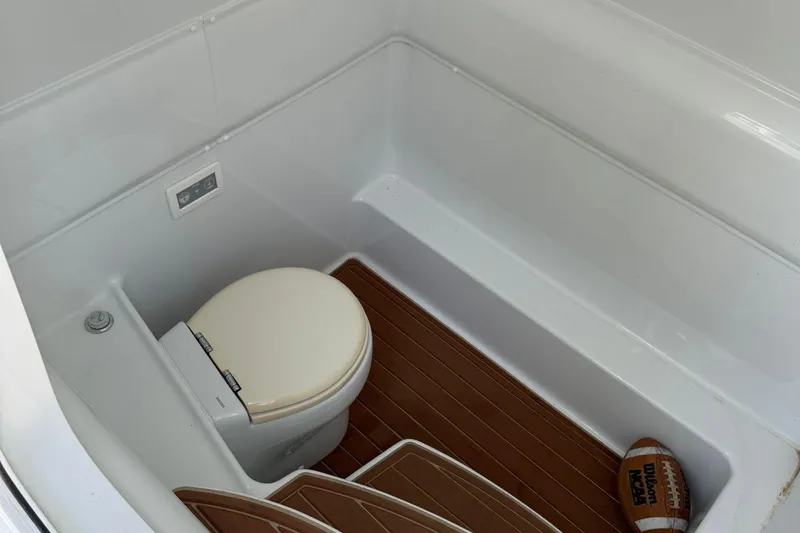  Yacht Photos Pics 2021 Yellowfin 39 boat interior with toilet and football on wooden floor.