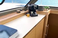 Modern kitchen area on a 2022 Nautitech 40 Open yacht with coffee maker and scenic view.