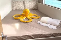 Cozy cabin in 2022 Nautitech 40 Open with plush octopus and scenic window view.