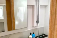Modern bathroom in 2022 Nautitech 40 Open yacht, featuring sleek sink, mirror, and shower.