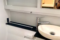 Modern bathroom interior of 2022 Nautitech 40 Open yacht, featuring sleek sink and window.
